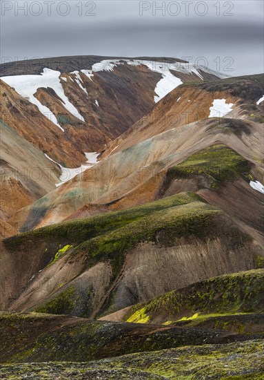 Colourful rhyolite mountains with remnants of snow