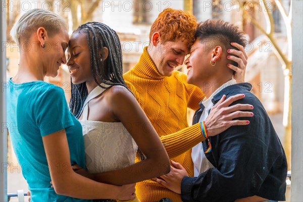 Portrait of couples of gay boys and lesbian girls embraced giving each other a kiss, lgtb concept