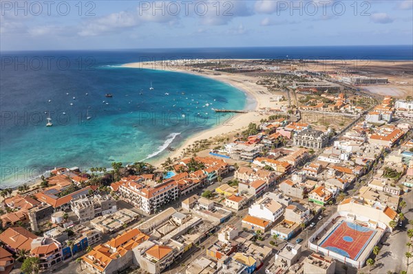 Pier and boats on turquoise water in city of Santa Maria, island of Sal, Cape Verde, Africa