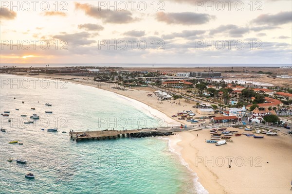 Pier and boats on turquoise water in city of Santa Maria, island of Sal, Cape Verde, Africa