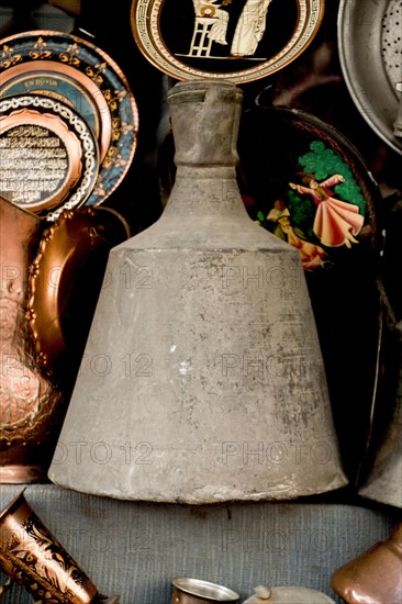 Ancient metal jug in oriental style in antique market