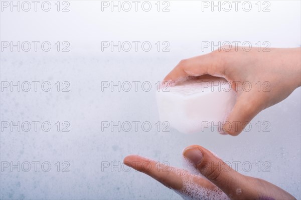 Hand washing and soap foam on a foamy background