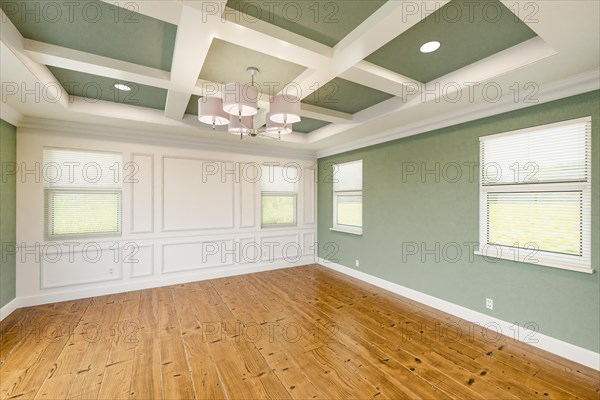 Beautiful light green custom master bedroom complete with entire wainscoting wall