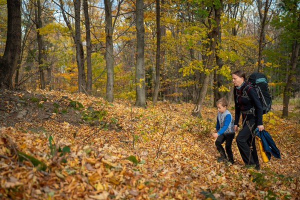 Mum and child are walking along the mountain hiking trail. Family spending time. Polish mountains