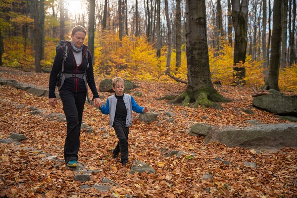 Mum and child are walking along the mountain hiking trail. Family spending time. Polish mountains