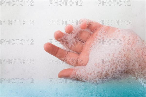 Hand washing and soap foam on a foamy background