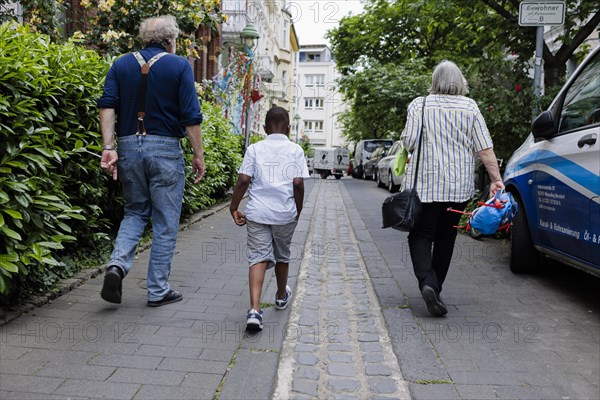 Temporary grandparents. Temporary grandparents volunteer to look after a boy from Africa for a few hours a week.