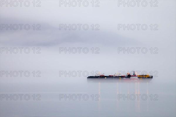 Cargo ship in the fog of Valdez Bay