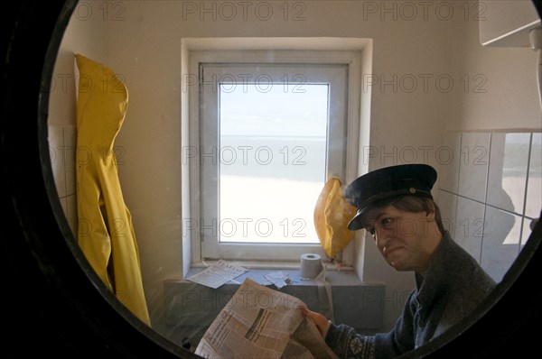 Dummy of lighthouse keeper reading the paper