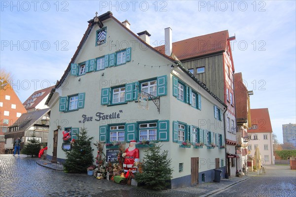 Restaurant Zur Forelle with Christmas decoration and green shutters