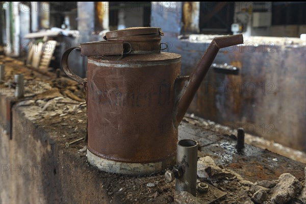 Rusty oil can in a former paper factory