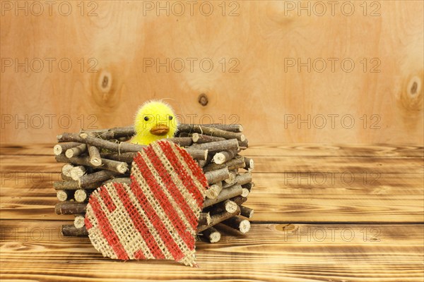 Chicks in a nest made of wood