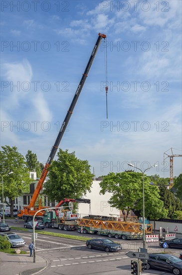 A construction crane is erected with a truck-mounted crane