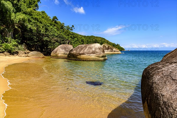Paradisiacal and deserted beach surrounded by rainforest in Ilha Grande bay in Angra dos Reis on the coast of Rio de Janeiro