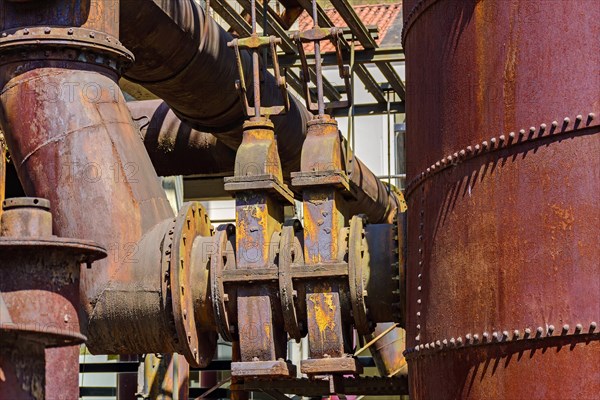 Corroded and rusty gears and pipes of old machinery for processing iron ore abandoned in Minas Gerais