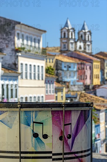 Colorful drum with the Pelourinho district with its historic and colorful houses and churches in the background in the city of Salvador