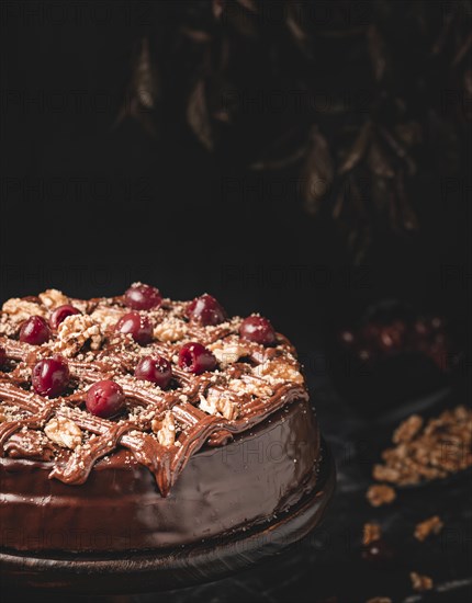 Chocolate cake with nuts and cherries