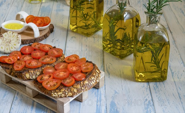 Toast bread with cherry tomato and olive oil with rosemary