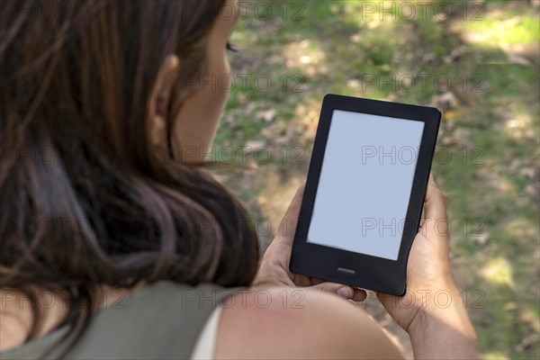 A modern black electronic book with a white blank empty screen