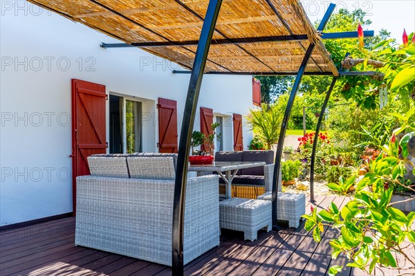 Summer house terrace. Terrace next to the vegetation of the garden in the shade of the sun