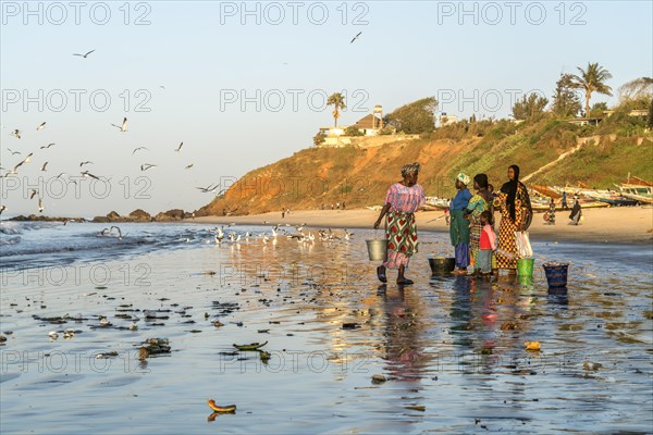 Fishermen's wives on the beach at the fish market