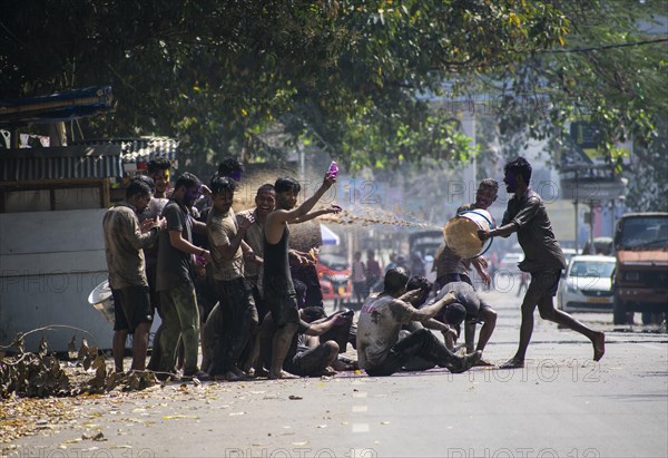 Revellers palying mud to celebrate Holi