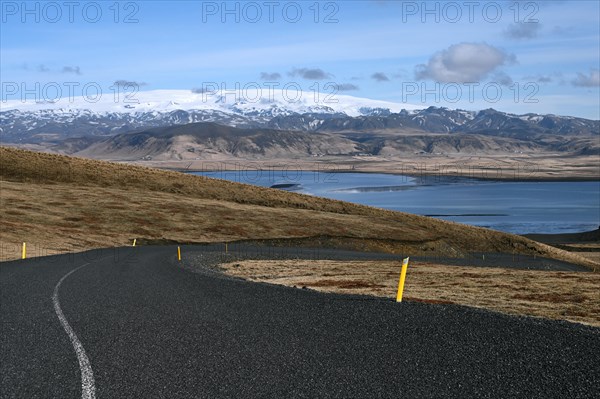 Road to the small peninsula of Dyrholaey on the south coast with a view of the glacier Myrdalsjoekull