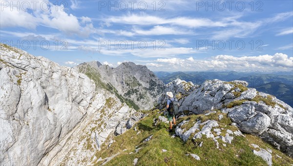 Mountaineer on a narrow ridge path