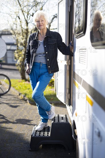 Subject: Pensioner in front of her caravan.