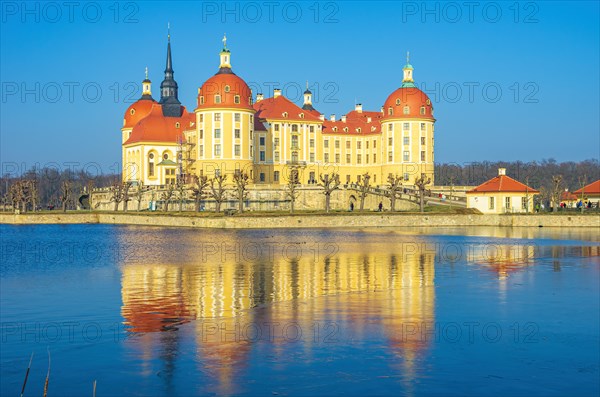 Exterior view of Moritzburg Castle in winter with half-frozen castle pond from the southwest