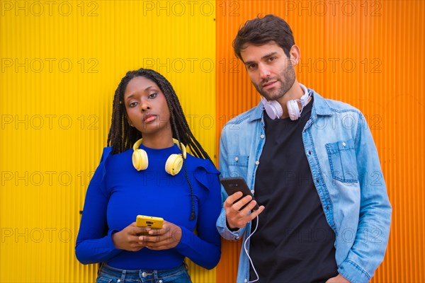 Portrait of multi-ethnic couple of Caucasian man and black ethnic woman on a yellow background