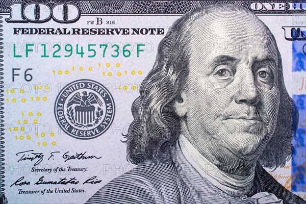 Close up of Benjamin Franklin face on 100 US dollar bill