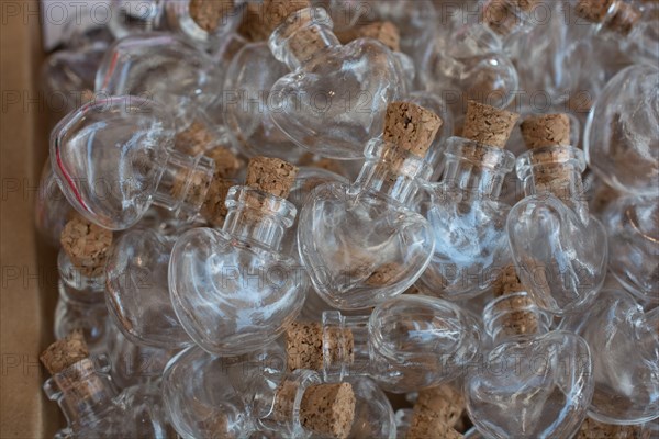 Planty of heart shaped glass bottles in a box