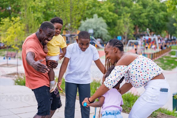 African black ethnic family with children in playground