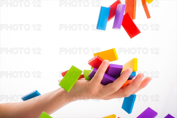 Falling colorful domino onto a hand