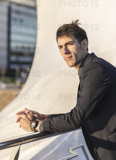 Portrait of sexy man over urban background at sunset