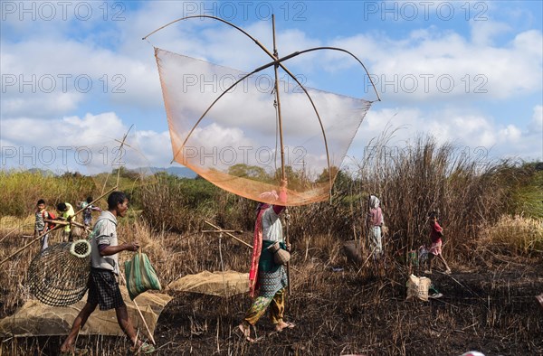 Villagers participate in a community fishing event on the occasion of Bhogali Bihu Festival at Goroimari Lake in Panbari village