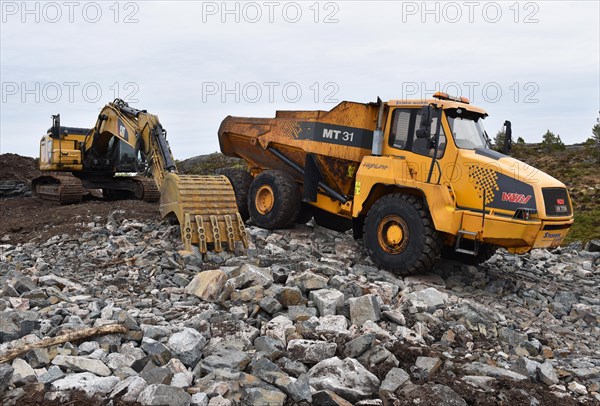 Tracked excavator and dump truck for road construction in Norway