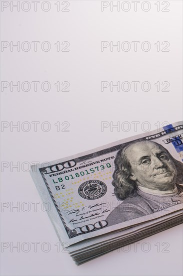 American dollar banknotes on a compass on white background