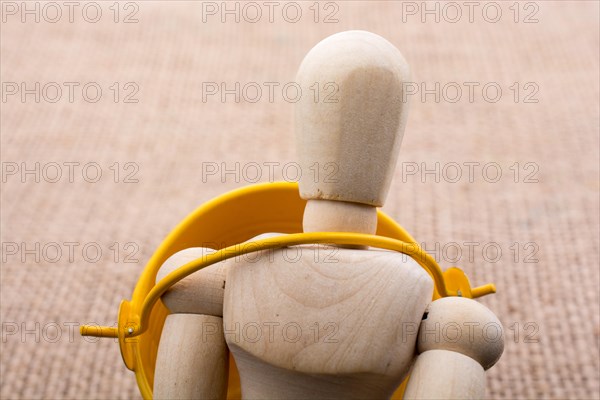 Wooden dolls of a man posing on canvas