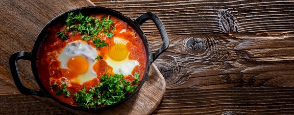 Shakshouka dish in a cast iron pan