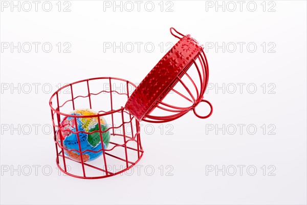 Small globe trapped in a red birdcage