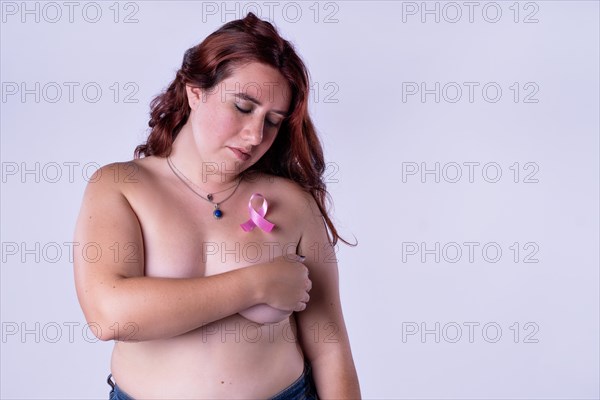 Young woman covering her breasts