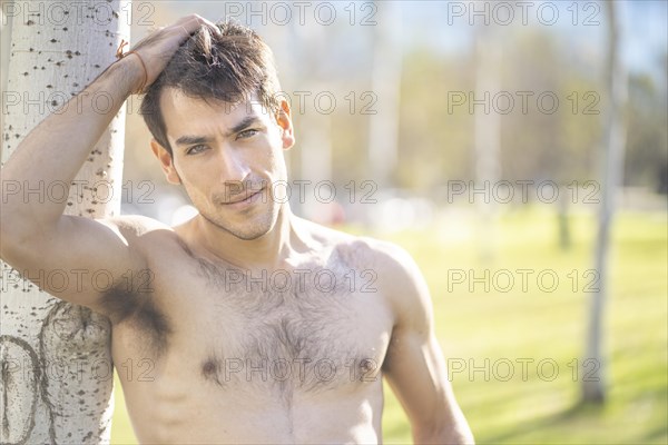 Attractive young man posing in the park after exercising