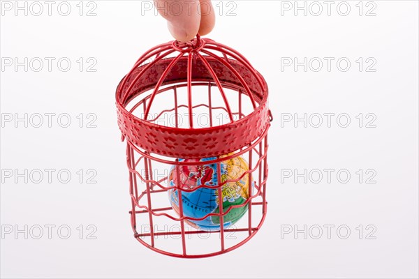 Small globe trapped in a red birdcage