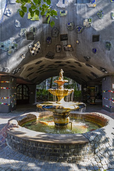 Fountain in the evening light in front of the Hundertwasser House