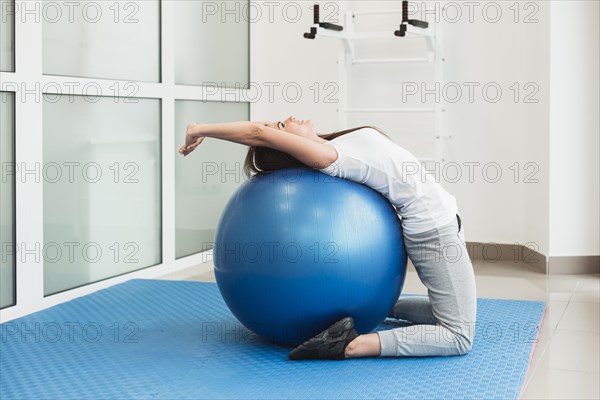 Female patient using exercise ball