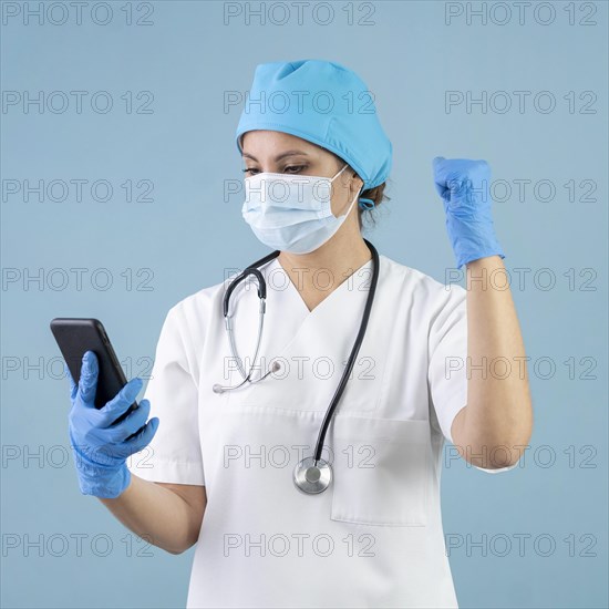 Medium shot doctor holding phone