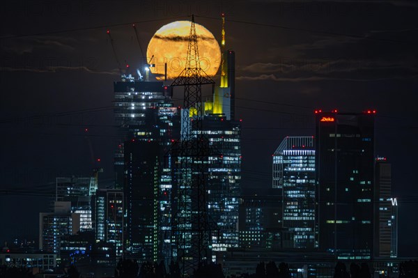 The super full moon rises behind the Frankfurt bank skyline