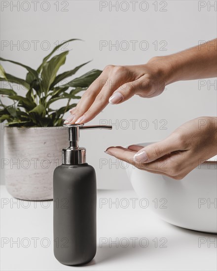 Sideways woman using liquid soap